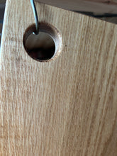 Chopping board made from one piece of oak with a 35mm hole. Oiled. 3720 0727
