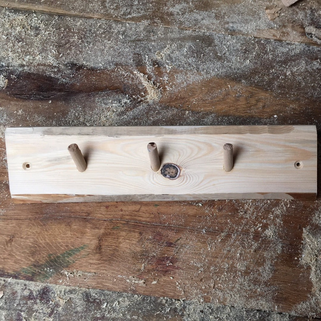 Coat rack made from reclaimed softwood and 3 hardwood dowels. Untreated. 7656 2775